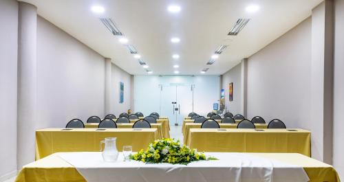 a conference room with chairs and tables and flowers at Ribai Hotels -Riohacha in Ríohacha