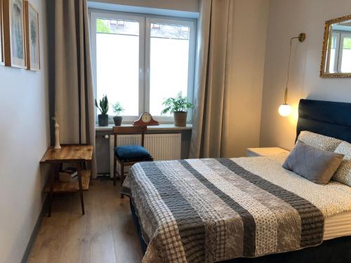 a small bedroom with a bed and a window at Amber in Gdańsk