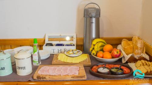 a counter top with a bunch of food on it at Reñaca House Bed & Breakfast in Viña del Mar