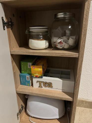 a shelf in a bathroom with food and other items at Wohnung nähe Porsche Museum in Stuttgart