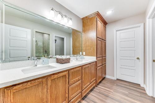 a bathroom with two sinks and a large mirror at Weslaco Home with Fenced Yard 2 Mi to Downtown in Weslaco