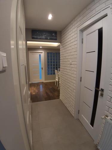 a hallway with a white door and a room at Cozy apartment close to the airport in Budapest