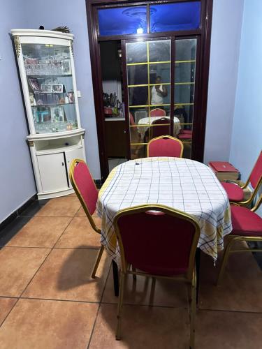 a room with a table and chairs and a refrigerator at Maqueda 2. Sanjo in Malabo