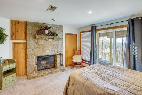 a bedroom with a fireplace and a bed at Wilmington Retreat with Deck, Lake Views and Game Room in Wilmington