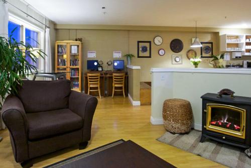 a living room with a chair and a fireplace at Painted Turtle Guesthouse in Nanaimo