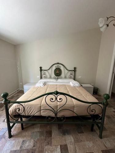 a bedroom with a large bed with a bed frame at La dimora di Pino in Ripa
