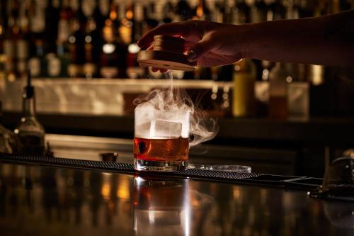 a person is pouring a drink into a glass at Marriott Marquis Washington, DC in Washington