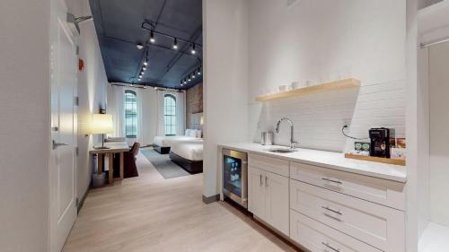 a kitchen with a sink and a living room at Studio 154 Luxury Hotel in Nashville