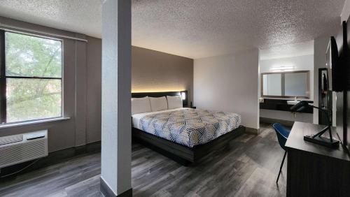 a hotel room with a bed and a window at Motel 6 Houston, TX - Medical Center - NRG Stadium in Houston