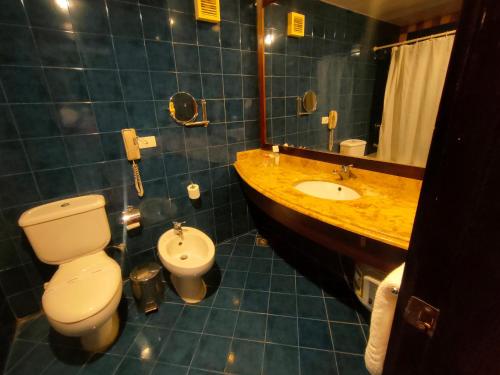 a bathroom with a white toilet and a sink at INGOING Marina in El Alamein