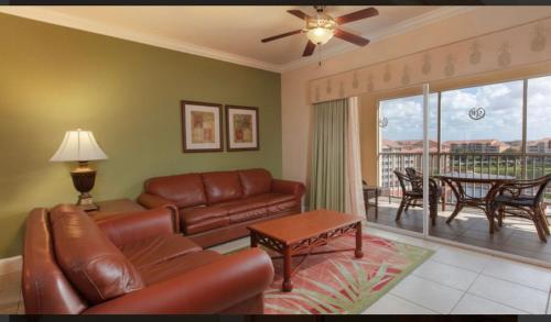 a living room with a leather couch and a table at Westgate Town Center Resorts in Orlando