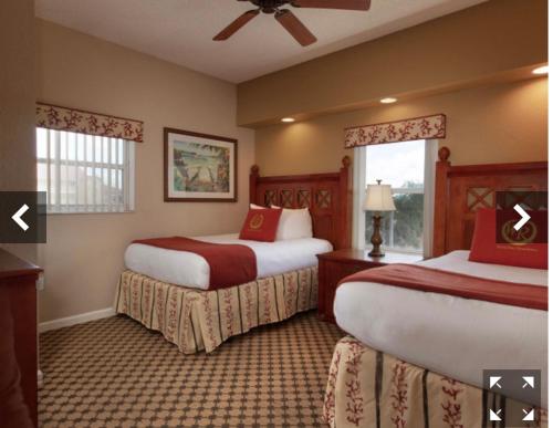 a hotel room with two beds and a window at Westgate Town Center Resorts in Orlando