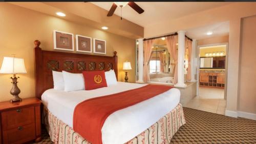 a bedroom with a large bed and a bathroom at Westgate Town Center Resorts in Orlando