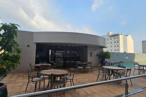 a group of tables and chairs on a patio at Apartamento de luxo no centro in Belém
