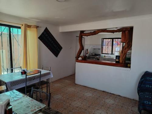a kitchen with a table and a mirror on the wall at Misky Wasi in San Pedro de Atacama