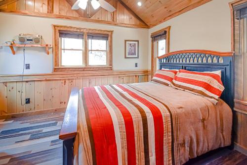 a bedroom with a bed and a tv on the wall at Just Chillin' in Blue Ridge