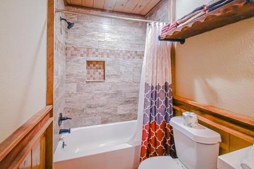 a bathroom with a toilet and a tub and a shower at Just Chillin' in Blue Ridge