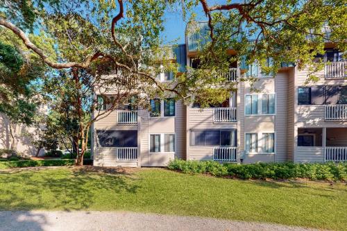 an apartment building with a lawn in front of it at Spa on Port Royal Sound 2101 in Hilton Head Island