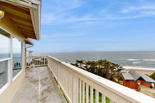 a balcony of a house with a view of the ocean at The Whale -Upper in Lincoln City