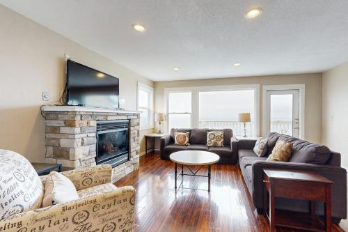 a living room with a couch and a fireplace at The Whale -Upper in Lincoln City