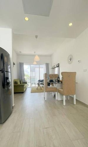 a living room with a kitchen and a dining room at Pool view peaceful 1 bedroom @ Hard Rock in Punta Cana