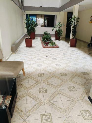 a lobby with a tiled floor with potted plants at Suite Hermosa ven descansa o trabaja El Rodadero 50m Playa in Gaira