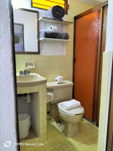 a bathroom with a toilet and a sink and a mirror at Olas Altas 534 Interior 4 in Puerto Vallarta