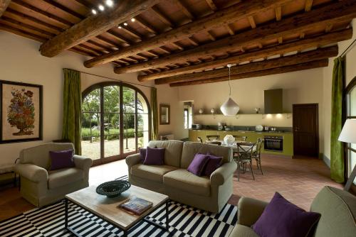 a living room filled with furniture and a large window at Villa Medicea di Lilliano in Grassina