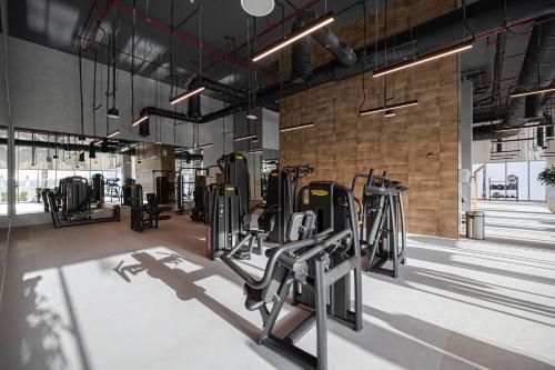 a gym with rows of treadmills and machines at Luxury 4BR Burj Khalifa & Fountain Views in Dubai