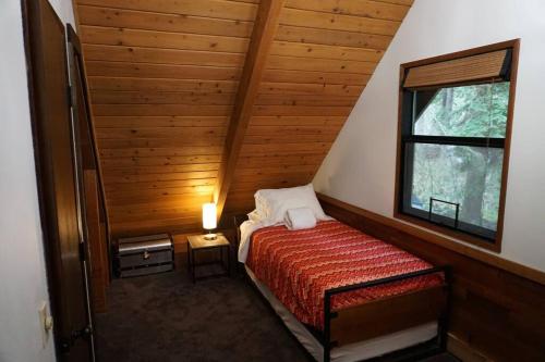 a small bedroom with a bed and a window at Mountainview Lodge in Deming
