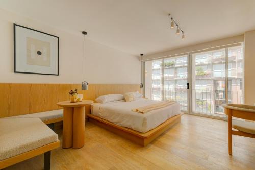 a bedroom with a bed and a large window at Capitalia Antara Polanco in Mexico City