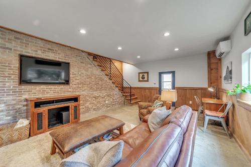a living room with a couch and a fireplace at Comfortable home near wineries and hiking farmhouse in Hendersonville