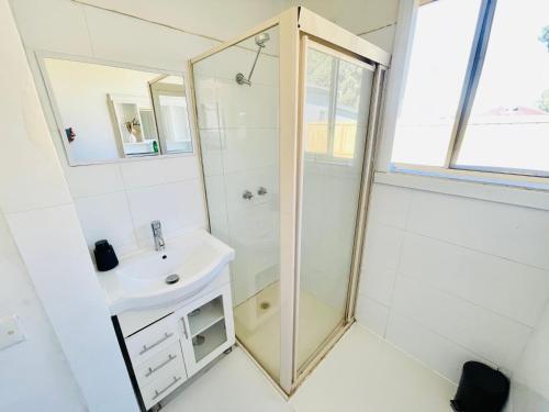 a bathroom with a shower and a sink at House in Thomastown in Melbourne