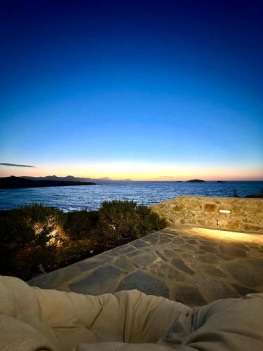 a bed with a view of the ocean at The Dice in Pachaina