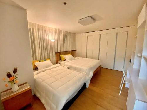a bedroom with two beds with white sheets at Gangnam Station Fun House in Seoul