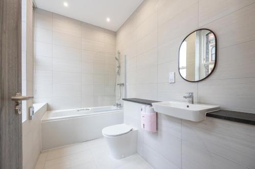 a bathroom with a sink toilet and a mirror at Amazing 1BD Apartment China Town Manchester in Manchester