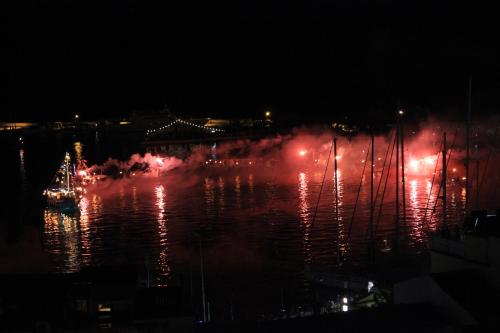 a group of boats on the water at night at Remezzo Hotel & Studios in Pythagoreio