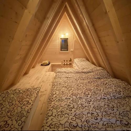 a bedroom with a bed in a small room at Woodland Cottage in Plav