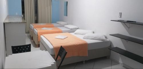 Ένα ή περισσότερα κρεβάτια σε δωμάτιο στο Pousada Verdes Mares guaratuba