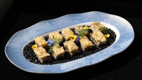 a blue and white plate with a plate of food at Holiday Inn Fuyang by IHG in Fuyang