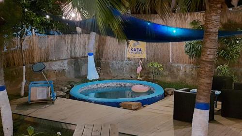 a hot tub in a yard with a palm tree at KAZA Balcones in Santa Veronica