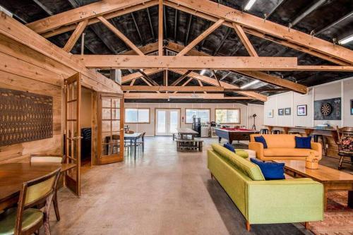 a large living room with wooden ceilings and furniture at Breakers - stay in a tiny home on the Oregon Coast in Waldport