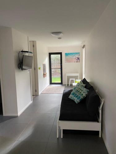 a bedroom with a bed and a tv in a room at Luxe Townhouse 2 in Inverloch