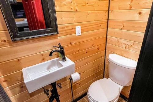 a bathroom with a toilet and a sink at Shorepine - Tiny Tranquility on the Oregon Coast! in Waldport