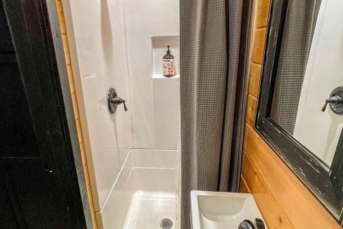a bathroom with a shower with a sink at Shorepine - Tiny Tranquility on the Oregon Coast! in Waldport