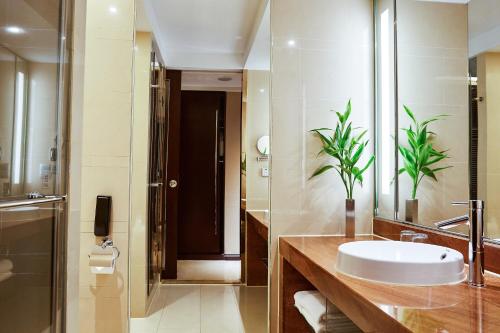 a bathroom with a sink and a mirror at Four Points by Sheraton Hangzhou, Binjiang in Hangzhou