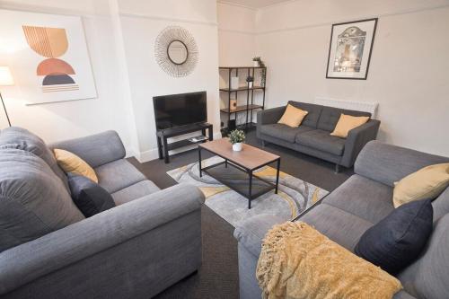 a living room with two couches and a television at October Disc - Long Stay - Contractors in Bristol