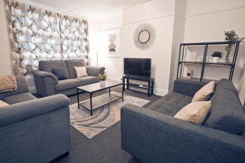 a living room with two couches and a television at October Disc - Long Stay - Contractors in Bristol