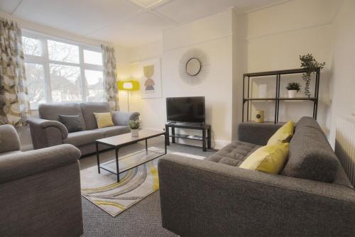 a living room with two couches and a television at May Disc - Long Stay - Contractors in Bristol