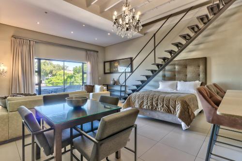 a bedroom with a bed and a living room at Heritage Square Apartments in Durbanville